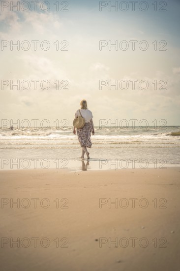 Woman on the beach in the evening sun, Zandvoort, Netherlands