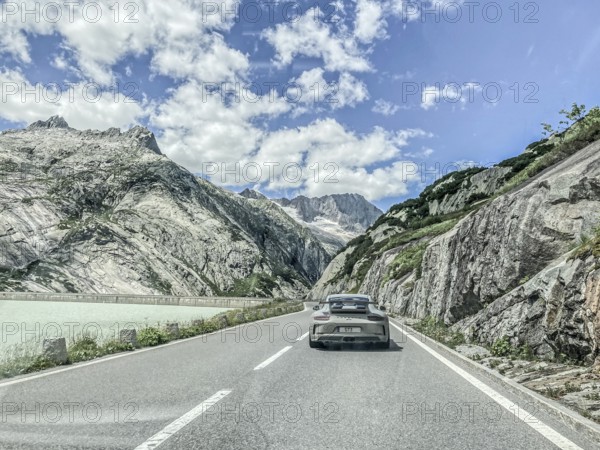 Photo with reduced saturation Porsche 911 GT3 on pass road of Grimselpass, Canton Uri, Switzerland,