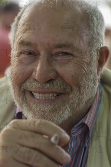 Portrait of a laughing gentleman with beard and cigarette, Bavaria, Germany, Europe