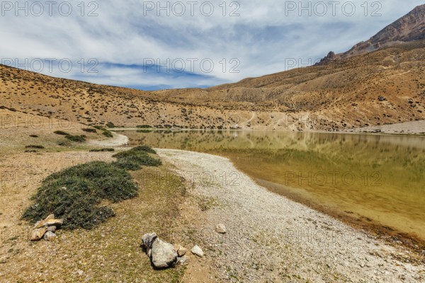 Himalayas mountains refelcting in mountain lake Dhankar Lake. Spiti Valley, Himachal Pradesh,