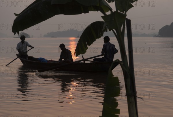 Fishermen boat passing next to a banana tree instralled for upcoming Chhath Puja festival, in the