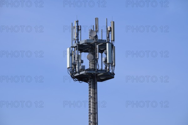 Mobile phone mast, transmission mast in front of sky, Hesse, Germany, Europe