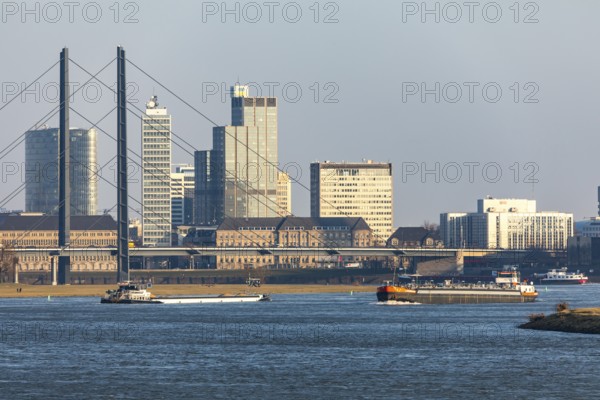 Düsseldorf, city centre skyline, skyscrapers, Rheinkniebrücke, Rhine, cargo ship