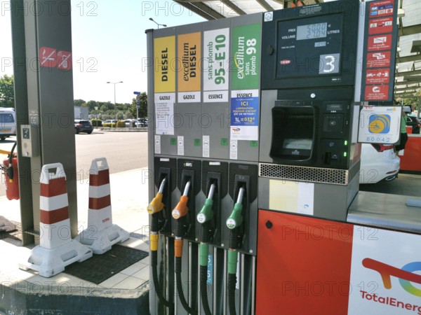 Petrol pump with nozzles for petrol and diesel at a motorway filling station in France, Automatic