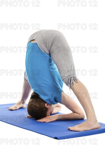 Yoga, young beautiful slender woman yoga instructor doing Wide Legged standing Forward Bend A