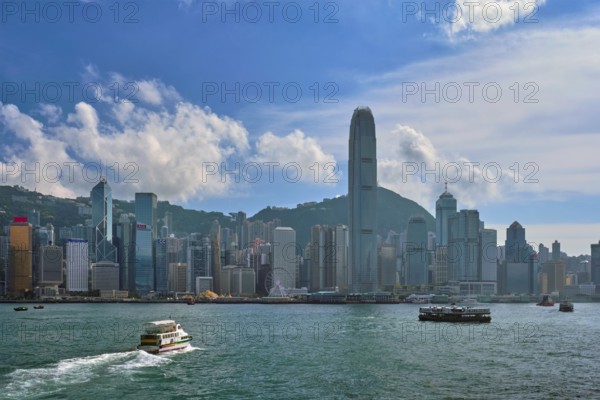 HONG KONG, CHINA, MAY 1, 2018: Boat in Victoria Harbour and Hong Kong skyline cityscape downtown