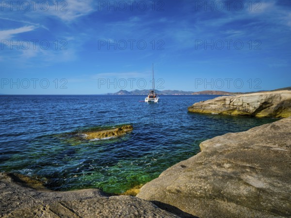 Yacht boat in Aegean sea at white rocks of Sarakiniko Beach, Milos island, Greece, Europe