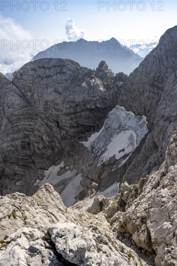 View of rock faces with blue ice glacier and summit of the Hochkalter, Berchtesgaden Alps, Bavaria,