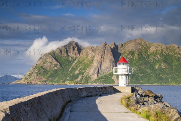 Lighthouse at harbour wall, fishing village Hovden, island Langøya, archipelago Vesterålen, Norway,