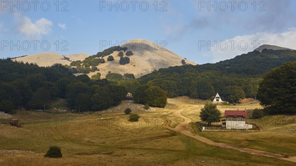 Ski resort in autumn, bare mountain top, building, dry plateau, trees, Madonie National Park,