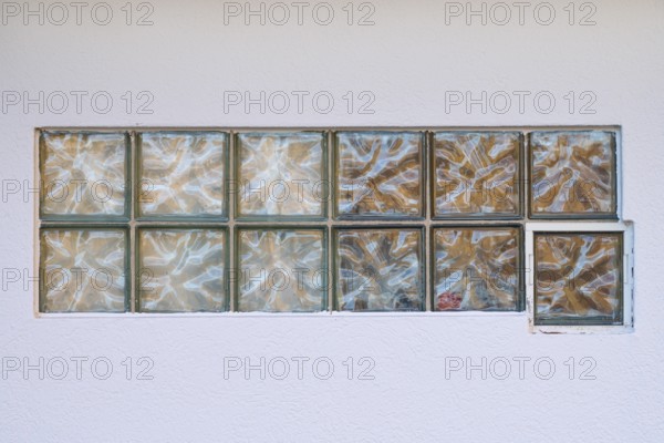 Glass blocks in whit wall, Germany, Europe
