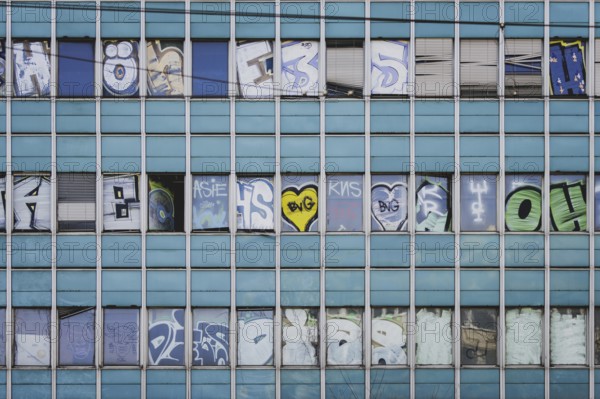 The logo of Berlin's public transport company BVG appears as graffiti on an empty office building