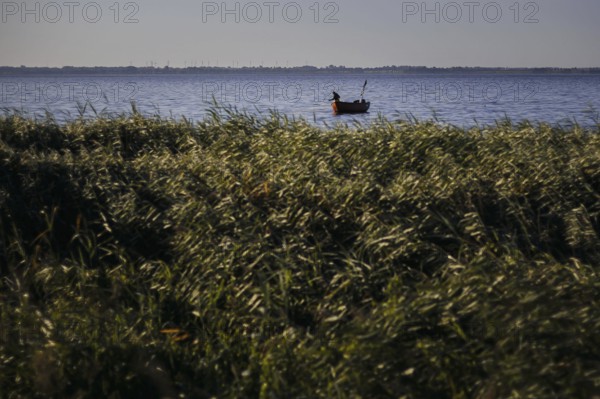 A fisherman hauls in his nets in the early morning near Born am Darß on the Bodstedter Bodden.