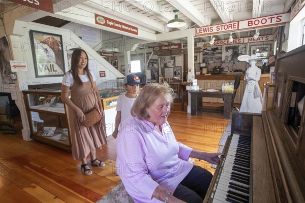 Eagle, Colorado, The Eagle County Historical Museum. A museum worker operates a player piano for