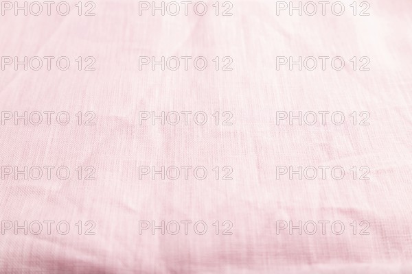 Fragment of smooth pink linen tissue. Side view, natural textile background and texture