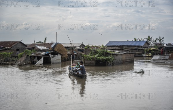 Morigaon, India. 4 July 2024. A settlement is partially submerged in flood in Morigaon district in