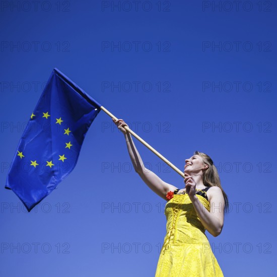 A woman poses with a European flag on the occasion of the 'Ä®20th anniversary of Poland's accession