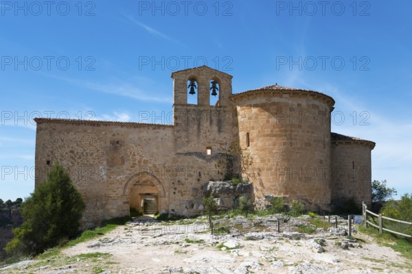 Lonely medieval church with stone walls and bell tower under a clear blue sky, Ermita de San