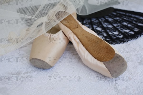 Ballet shoes, pointe shoes, fan, lace, tulle, still life, dance shoes covered with satin in light