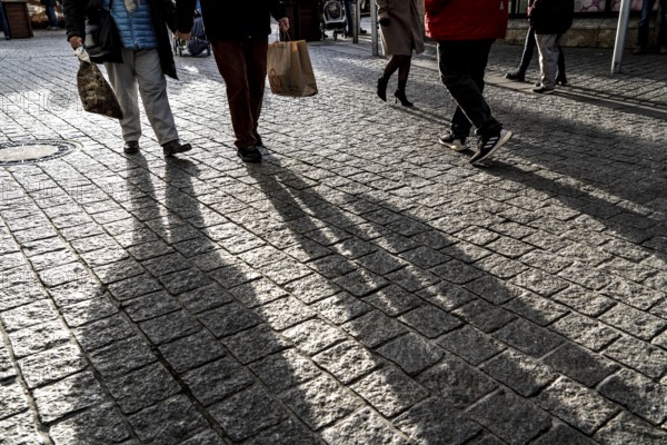Pedestrians in a pedestrian zone, winter, long shadows, Dortmund, North Rhine-Westphalia, Germany,