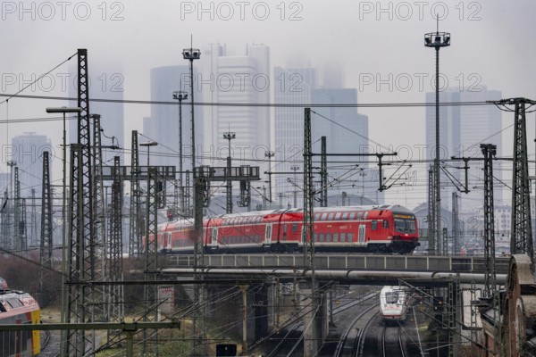 Railway tracks with regional trains, after freezing rain, in front of Frankfurt main station,