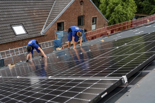 Installation of solar modules on the roof of a barn on a farm, over 240 photovoltaic modules are