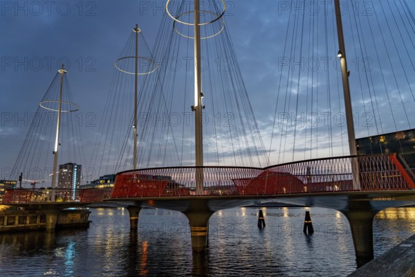 Cyclists on the Cirkelbroen cycle and pedestrian bridge, over the harbour, in the Christianshavens