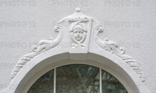 Relief of a boy's head above the fenaster of the oldest kindergarten in Lauf, 1850, Alter Schulhof