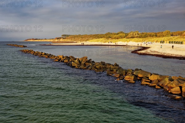 Baltic Sea beach, walkers on the Baltic Sea coast on Wustrow beach in the evening light, evening