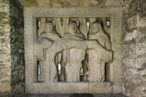 Relief in wall, 3 woman holding the dead Jesus, Mary, Christian art, garden of St John's Church,