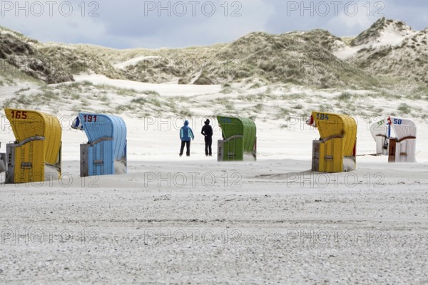 Holidaymakers walk past beach chairs on the beach of Süddorf, Insel amrum, 27.05.2021