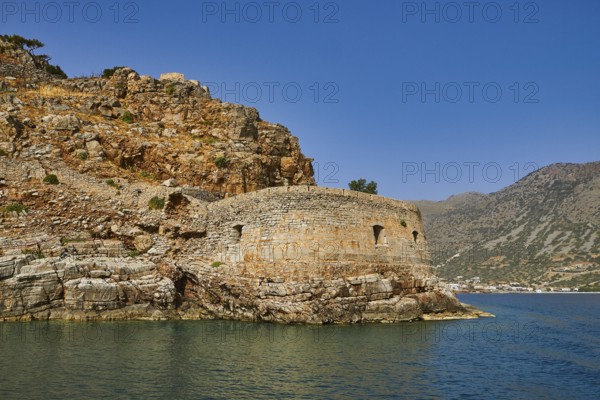 Round, stony old fortress on the seashore, embedded in a hilly landscape, Venetian sea fortress,