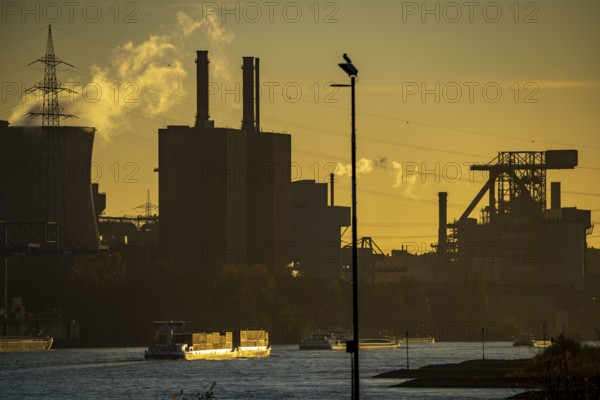 Sunset, cargo ships on the Rhine, steelworks, Hüttenwerke Krupp Mannesmann, cooling towers of the