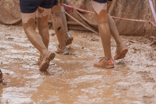 Shoes in the mud during a dynamic outdoor obstacle course