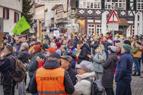 Demonstrators with banners in front of half-timbered houses, Assembly with police and respect sign,
