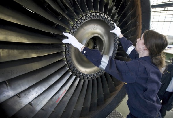 Trainees in the training workshop of Trainico, training as aircraft mechanics on a jet engine,