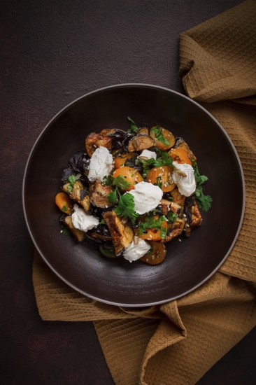Warm Salad with crispy eggplant and tomatoes, cottage cheese, spices, herbs, sesame seeds,
