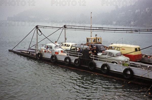Cars and vans on a car ferry between Kingswear and Dartmouth, Devon, England, United Kingdom, early