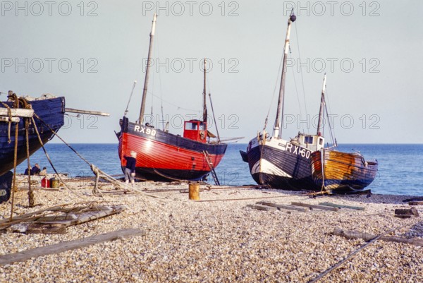 Fishing boats on the pebble beach at Rye, East Sussex, England, UK 1956