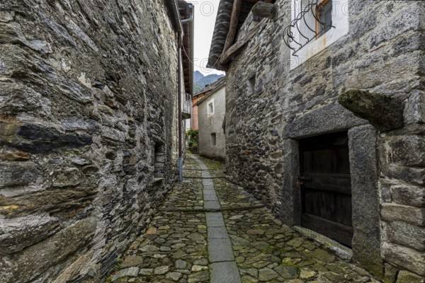 Typical Ticino stone houses in a narrow alley in the mountain village of Bordei, Centovalli, Canton