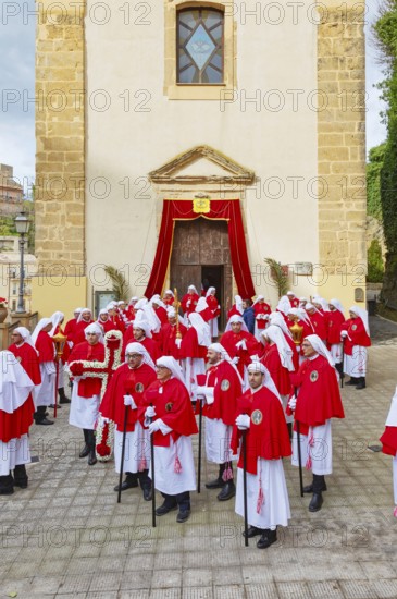 Confraternity of penitents gathering outside San Leonardo church, Enna, Siclly, Italy, Europe