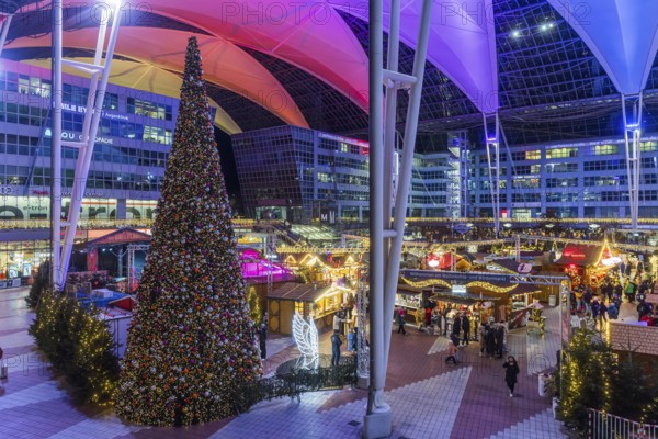 Christmas market at the airport in the evening, market stalls decorated for Christmas in front of