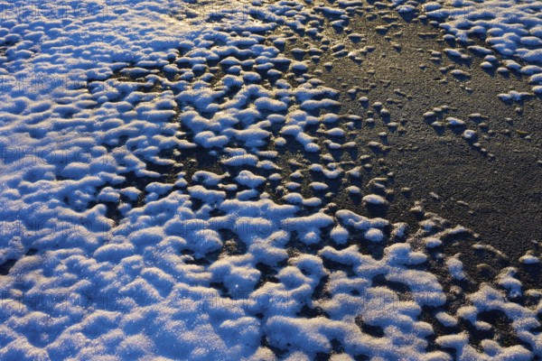 Snow cover with contrasting patterns in the light of the setting sun, winter, Wasserkuppe,