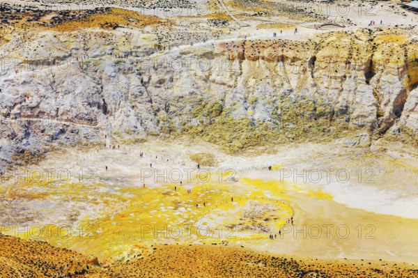 People walking around Stefanos crater moonlike landscape, Nisyros Island, Dodecanese Islands,