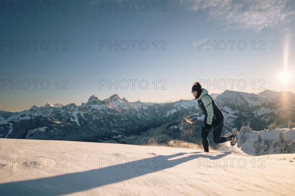 Summit bliss in the snow-covered winter landscape in the Tannheimer Tal in the Alps on the