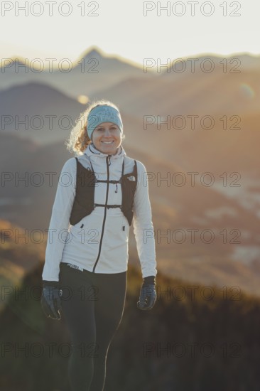 Trail running in autumn on the Jochberg on Lake Walchensee against the wonderful backdrop of the