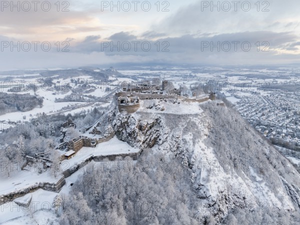 Aerial view of the snow-covered Hegau volcano Hohentwiel with Germany's largest castle ruin on a