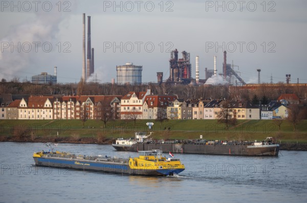 Duisburg, North Rhine-Westphalia, Germany - Cityscape in the Ruhr area with cargo ship on the Rhine