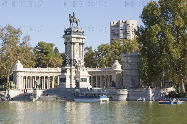 Rowing boats in boating pond of Estanque, El Retiro park, Madrid, Spain, monument to King Alfonso