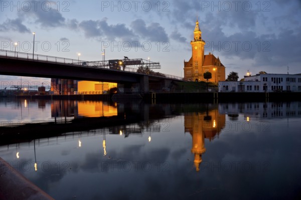 The old harbour office in the neo-renaissance style in the harbour in Dortmund at dusk, North